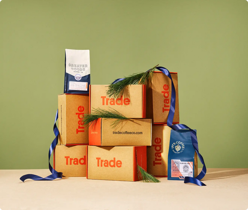 coffee bags and gift boxes on green background