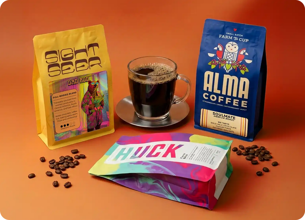 Three coffee packages from different brands on an orange background with coffee beans and a cup of coffee.