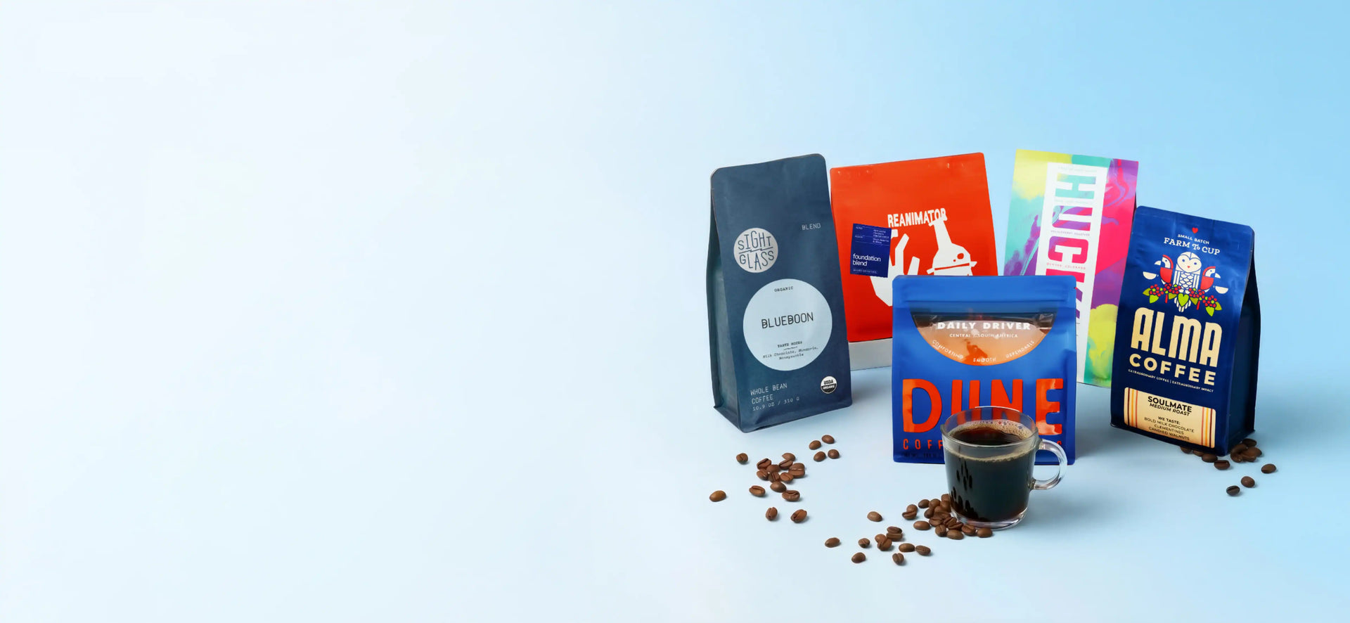 Assorted coffee packages with a cup of coffee on a light blue background